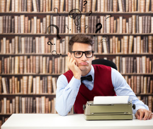 Old fashioned writer thinking with question marks over head